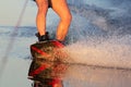 Men`s feet on a wakeboard in water.guy on the river and is preparing to go wake boarding Royalty Free Stock Photo