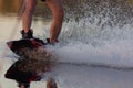 Men's feet on a wakeboard in water.guy on the river and is preparing to go wake boarding Royalty Free Stock Photo