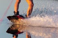 Men`s feet on a wakeboard in water.guy on the river and is preparing to go wake boarding Royalty Free Stock Photo