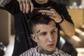 Men`s hairstyling and haircutting in a barber shop . Men`s Hairdressers barbers. Royalty Free Stock Photo