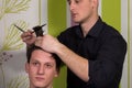 Men's hairstyling and haircutting with hair clipper and scissor Royalty Free Stock Photo