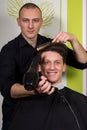 Men's hairstyling and haircutting with hair clipper and scissor Royalty Free Stock Photo