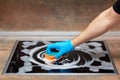 Men`s hand washes the electric stove with a sponge and foam. Close-up view Royalty Free Stock Photo