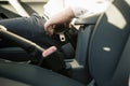 Men`s hand fastens the seat belt of the car. Drive safely concept