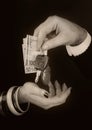 Men`s hand giving to  woman`s hand euro banknotes and car keys Royalty Free Stock Photo