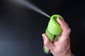 Men`s Hand Holding Air Freshener Bottle and Spraying.