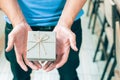 Men`s hand holding gift box. Royalty Free Stock Photo