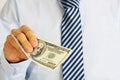 Men's hand holding money american hundred dollar bills. Hand of businessman offering money. Royalty Free Stock Photo