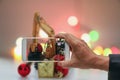 Men `s hand holding a smartphone. Christmas Photography