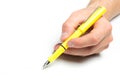 Men`s hand holding yellow fountain pen on isolated background, close up Royalty Free Stock Photo