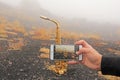 Men`s Hand Photographs on the Smartphone Saxophone. Golden Alto Royalty Free Stock Photo