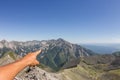 Men`s hand pointing forward with your finger on the mountain pea Royalty Free Stock Photo