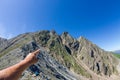 Men`s hand pointing forward with your finger on the mountain pea Royalty Free Stock Photo