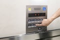 Men`s hand with the press of control buttons interior elevator have braille panel for the disabled. Royalty Free Stock Photo