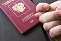 Men`s Hand shows the fico on passport backgound. Symbol of sanctions. Negative concept. Closeup Royalty Free Stock Photo