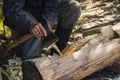 The men& x27;s hands of a carpenter with an axe in the process of working close-up. A man carpenter works with an axe. Royalty Free Stock Photo