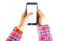 Men`s hands in a checkered hipster shirt are holding a smartphone on a white background. The screen is white and black. Hands Royalty Free Stock Photo