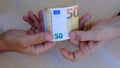 men's hands exchange money, euro banknotes