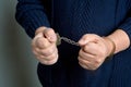 Men& x27;s hands in handcuffs close up Royalty Free Stock Photo