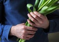 Men`s hands hold flowers. Man with flowers. Flowers for your beloved woman. A bouquet in hands. Date. Confession. Royalty Free Stock Photo