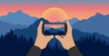 Men`s hands hold phone and take picture of beautiful nature, landscape. Silhouette of forest and mountains on background of sunse