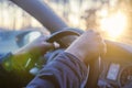 Men`s hands hold steering wheeln of car close-up. The man is driving the car from the inside. Royalty Free Stock Photo