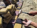 Men`s hands install a colorful bright beautiful paving slab with a rubber mallet Royalty Free Stock Photo