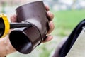 Men`s hands lubricate the gutter with a sealing agent Royalty Free Stock Photo