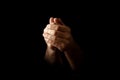 Men`s hands in prayer on a black background. The concept of faith, prayer, mourning, forgiveness, confession Royalty Free Stock Photo