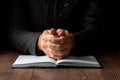 Men`s hands in prayer on a black background. The concept of faith, prayer, mourning, forgiveness, confession Royalty Free Stock Photo