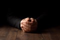 Men`s hands in prayer on a black background. The concept of faith, prayer, mourning, forgiveness, confession Royalty Free Stock Photo