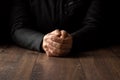 Men`s hands in prayer on a black background. The concept of faith, prayer, mourning, forgiveness, confession Royalty Free Stock Photo