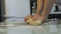 Men`s hands prepare pizza dough on the table in the kitchen