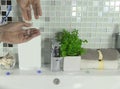Men`s hands press on the soap dispenser.