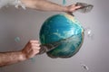 Men`s hands tear off a plastic bag from the globe of planet Earth. The concept of environmental protection. Eco Royalty Free Stock Photo