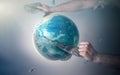 Men`s hands tear off a plastic bag from the globe of planet Earth. The concept of environmental protection. Eco. Tint and copy Royalty Free Stock Photo