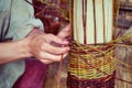 Men`s hands for weaving handmade baskets. Products from twigs in a rustic style