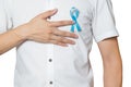 Men`s healthcare concept - male hand pointing to light blue ribbon for prostate cancer at left chest isolated on white background Royalty Free Stock Photo