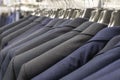 Men`s jackets suits in blue and gray in a men`s clothing store. Men`s business suit Royalty Free Stock Photo