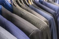 Men`s jackets suits in blue and gray in a men`s clothing store. Men`s business suit