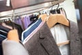 Men`s jackets suits on hangers in store, close-up shot Royalty Free Stock Photo
