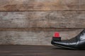 Men`s leather shoes and cleaning sponge on wooden table, space for Royalty Free Stock Photo