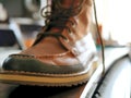 Men`s leather work boot sitting on desk.