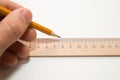 Men's left hand holding a pencil on over white