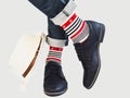 Men`s legs, bright socks, hat and shoes