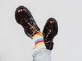 Men's legs in bright, striped, multi-colored socks