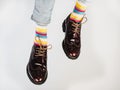 Men's legs in bright, striped, multi-colored socks