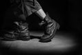 Men`s legs in old military boots. Royalty Free Stock Photo