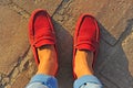 Men`s legs in red moccasins