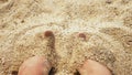 Men`s Legs on the sea sand and wave, Relaxation on the ocean beach, Summer holidays.